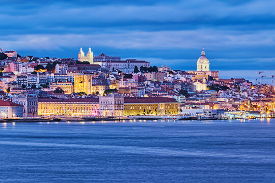 View of Lisbon over Tagus river with ferry boats in evening twilight. Lisbon, Portugal