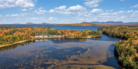 Freight train in autumn panorama at Moosehead Lake - Maine - Train tracks along the lakeshore