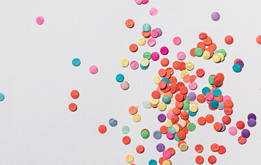 Colorful paper confetti on the white background. Top view