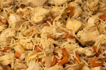 Tasty pilaf with chicken as background.