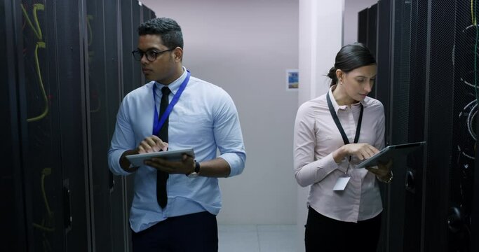 Tablet, engineering and server room, woman and man, teamwork and cybersecurity in network administration. Tech employees, system maintenance and online update, technician team in data center together