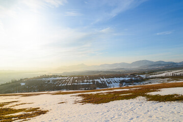 View from hill Nicovo to the part of Liptovsky Mikulas city in the winter and to Low tatras. Slovakia, Liptov region. Snowy, cold and sunny weather.