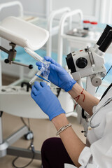 Fototapeta premium Speculum close-up in gynecologist hands for colposcopy procedure to closely examine cervix, vagina and vulva of girl in gynecology clinic.