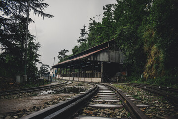 Fototapeta na wymiar View of Shimla railway station on a rainy day - Kalka Shimla Toy Train - UNESCO World Heritage Site - Rail Transportation 