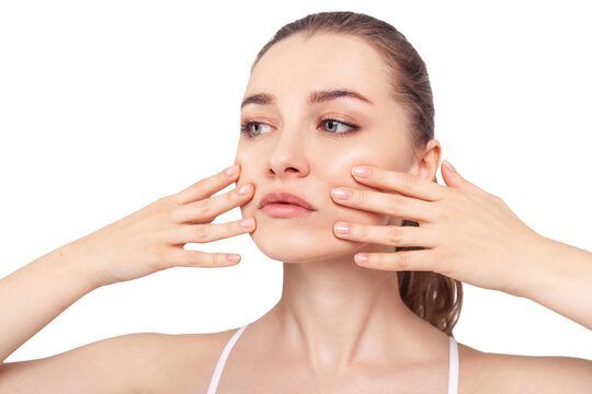 Young woman makes massage herself on face.