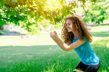 Fototapeta premium Happy woman doing exercises in public park with Fitness Bands Elastic. fitness, sport and exercise concept