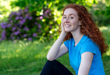 Happy  Woman Resting After Exercising In Park.  Fitness, sport and exercise concept