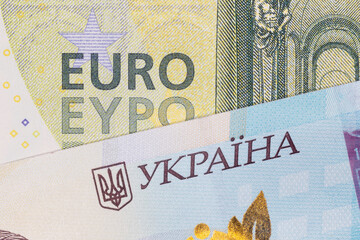 one hundred euro and one thousand Ukrainian hrivnya banknotes