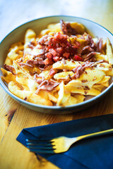 Sliced baked potatoes with ham and cheese, on a plate