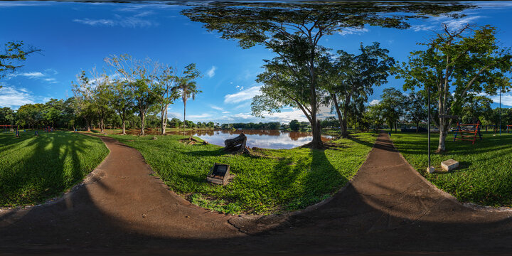 square with pedestrian path next to playground, lake and skate park