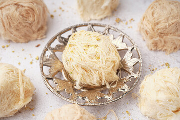 Plate with tasty Turkish Pismaniye on light background