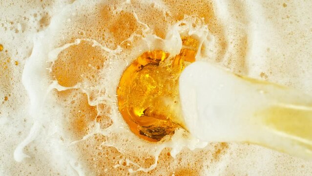 Super Slow Motion Shot of Pouring and Splashing Beer Background at 1000fps.