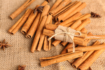 Heap of cinnamon sticks and anise stars on sack napkin