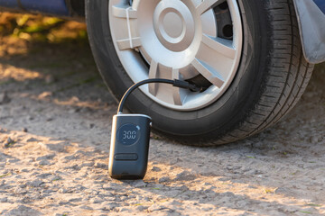 Inflating car tires with a portable wireless air pump outdoor