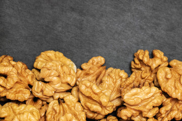 Walnuts. Walnut kernels on dark stone table. Top view