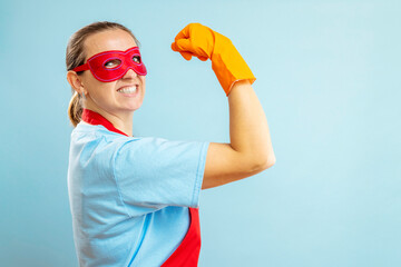 Confidence superhero house cleaner showing her powerful muscle
