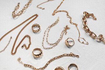 Beautiful golden jewellery on white textured background