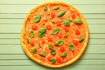 Tasty pizza margarita on green wooden background