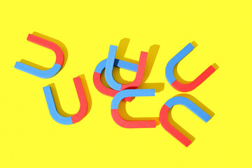 Horseshoe shaped magnets on yellow background