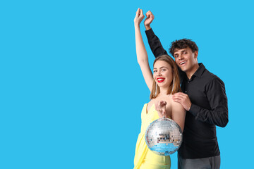 Beautiful prom couple with disco ball on blue background - obrazy, fototapety, plakaty