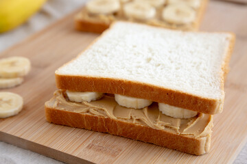 Homemade Peanut Butter Banana Sandwich on a Bamboo Board, side view. Close-up.
