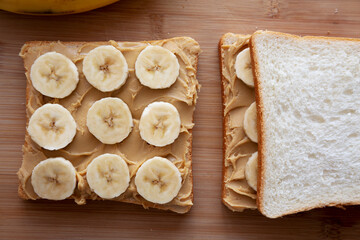 Homemade Peanut Butter Banana Sandwich on a Bamboo Board, top view. Overhead, from above, flat lay.