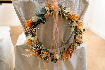 Flower Ring at a chair for a wedding. Decoration Beautiful