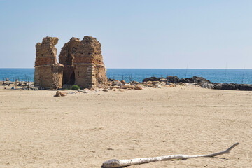old ruin on a beach with sea in background