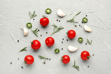 Naklejka na ściany i meble Composition with ripe cherry tomatoes, rosemary, jalapeno and peppercorn on color background