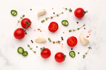 Composition with ripe cherry tomatoes, jalapeno and spices on light background