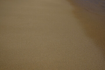 Golden sand at the beach of Mylopotas in Ios Greece