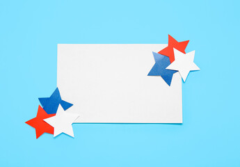 Blank greeting card and stars on blue background. Independence Day celebration