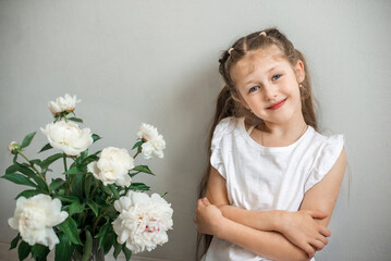 little girl with a bouquet of white flowers peonies 