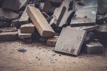 Construction waste. A pile of cement pressed materials, concrete debris, of grey slabs, curbs and...