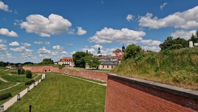 timelapse. Fortifications of the fortress and city of Zamosc. White clouds moving across the blue sky. Poland