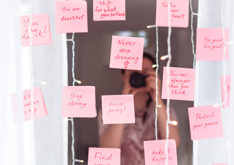 inspirational quotes on pink sticker on the mirror,handwriting text