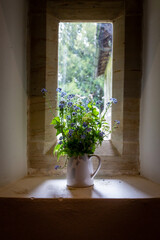 Pretty flowers arranged in a jug, with a shallow depth of field