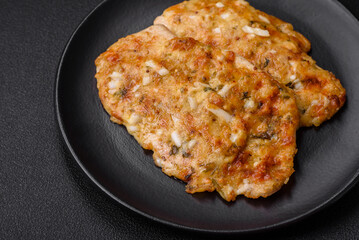 Delicious fried chicken breast in batter with mustard, salt, spices and cheese