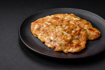 Delicious fried chicken breast in batter with mustard, salt, spices and cheese