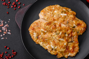 Delicious fried chicken breast in batter with mustard, salt, spices and cheese