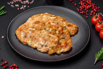 Delicious fried chicken breast in batter with mustard, salt, spices and cheese