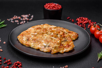 Delicious fried chicken breast in batter with mustard, salt, spices and cheese