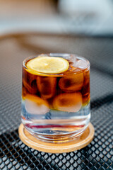 glass of cold brew with ice and lemon, expresso