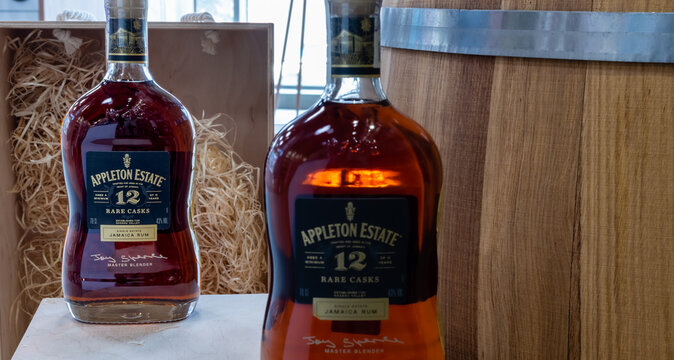 Bottles of Jamaica Rum Appleton Estate 12 years aged close-up on background of oak barrel and wooden boxes. Ukraine, Zhytomyr, June, 5, 2023