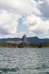 Piedra del Peñol seen from the Guatapé dam in Antioquia, Colombia with copy space. 721 foot monolith. Tourist spot.