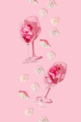 Layout made of glasses of petals  and seashells on pink background. Creative romantic decoration party or ceremony concept.