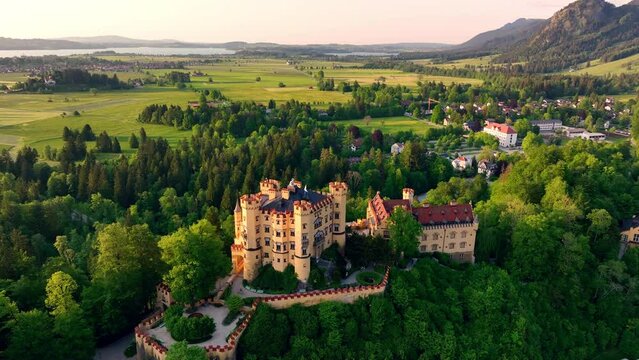Aerial view of hohenschwangau Castle, Bavaria, Germany. Fairytale Castle Sunset View. 4k drone flight point of view, Europe.