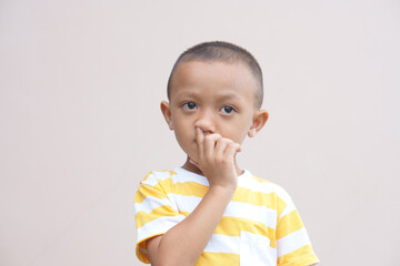 The boy poked his finger into his nose.
