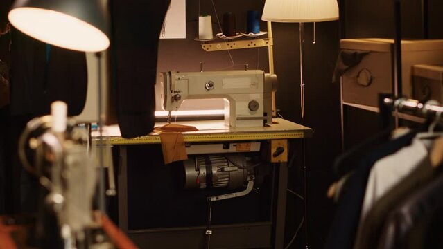 Industrial sewing machine workstation and fashion atelier, tailoring and needlework equipment used to create custom made clothes. Small business in textile industry, clothing atelier.