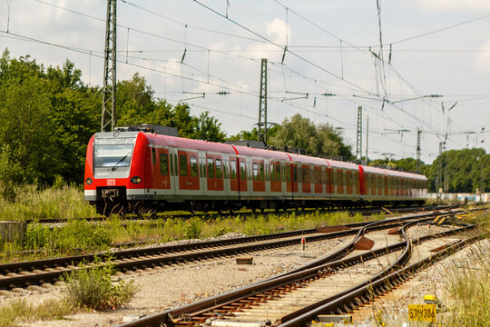 Munich, Bavaria, Germany - June 05th 2023: A S-Bahn train of DB (deutsche Bahn) driving by. DB is a german railway service